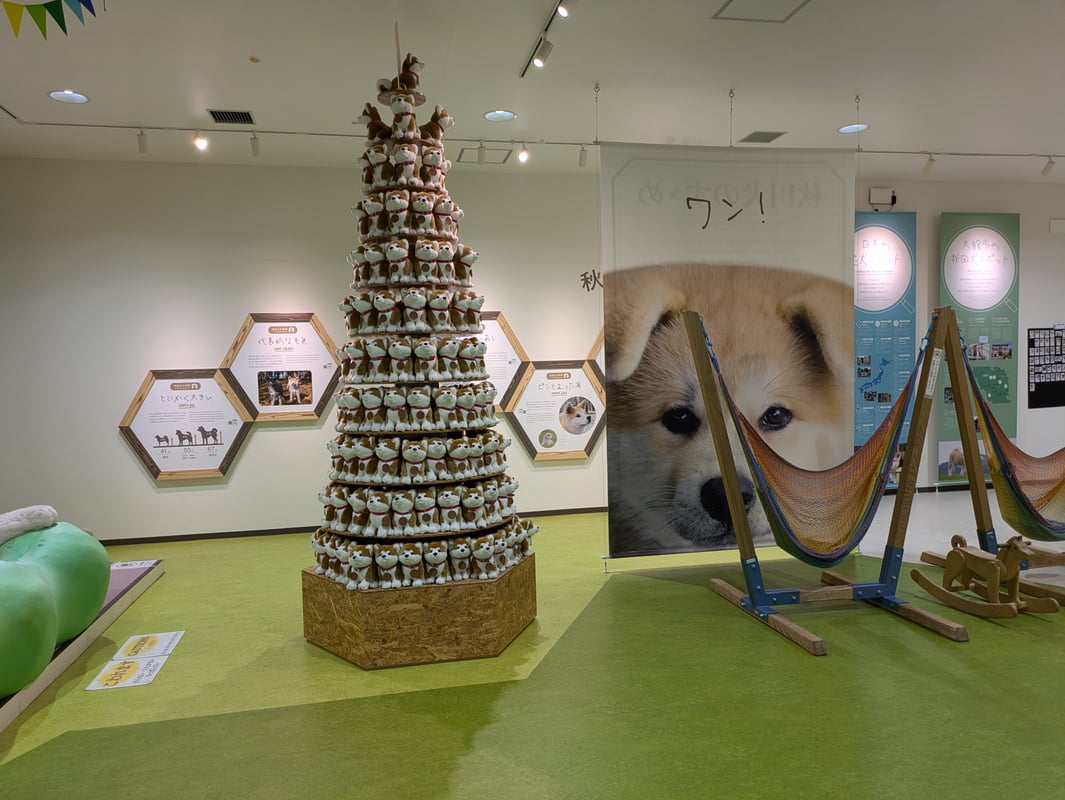 The image shows a tower made by stacking multiple Masaru plush toys.