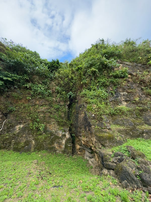 The image shows a large stone quarry with workers cutting and collecting stone blocks, and tall rock faces in the background.